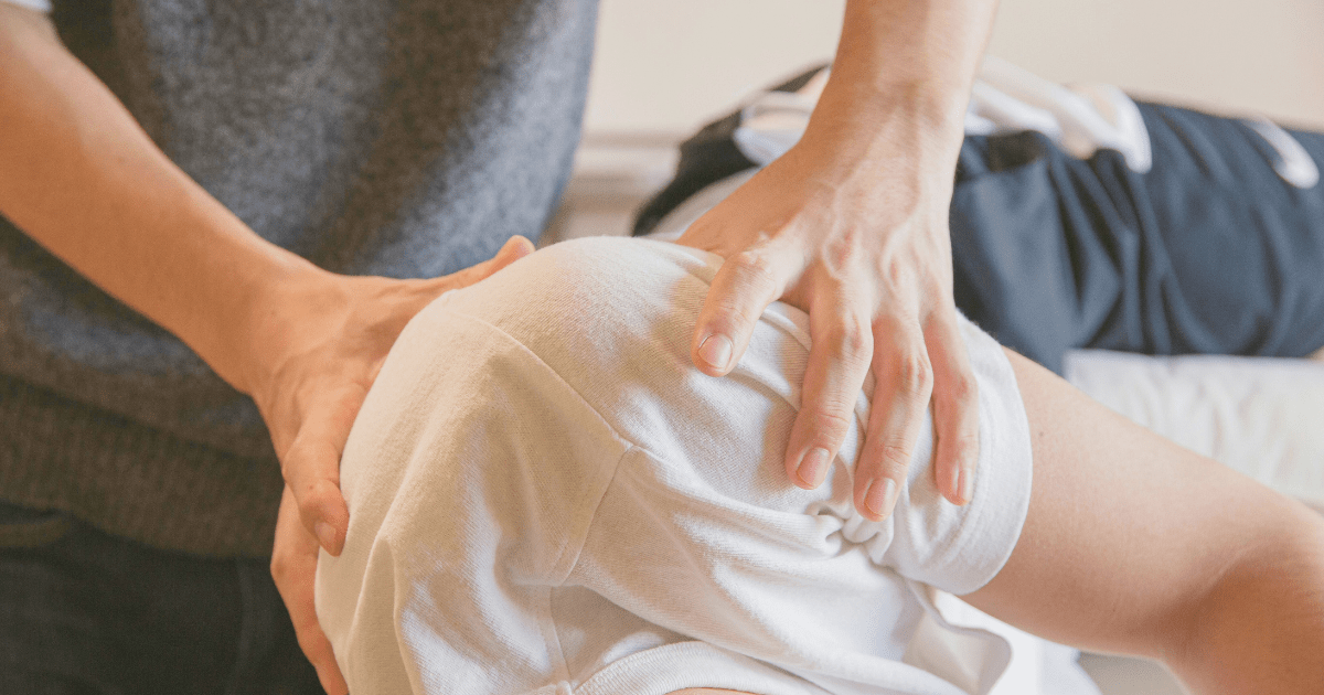 Therapist performing manual therapy on a patient's knee during a Knee Pain Physical Therapy NYC session at ProkineticsPT.